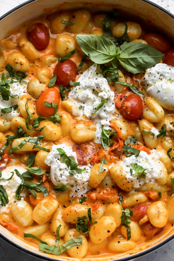 A close up of some food with cheese and tomatoes