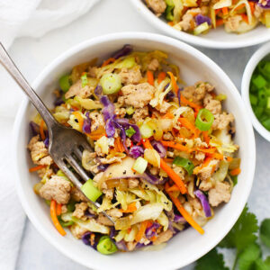 A bowl of food with meat and vegetables.