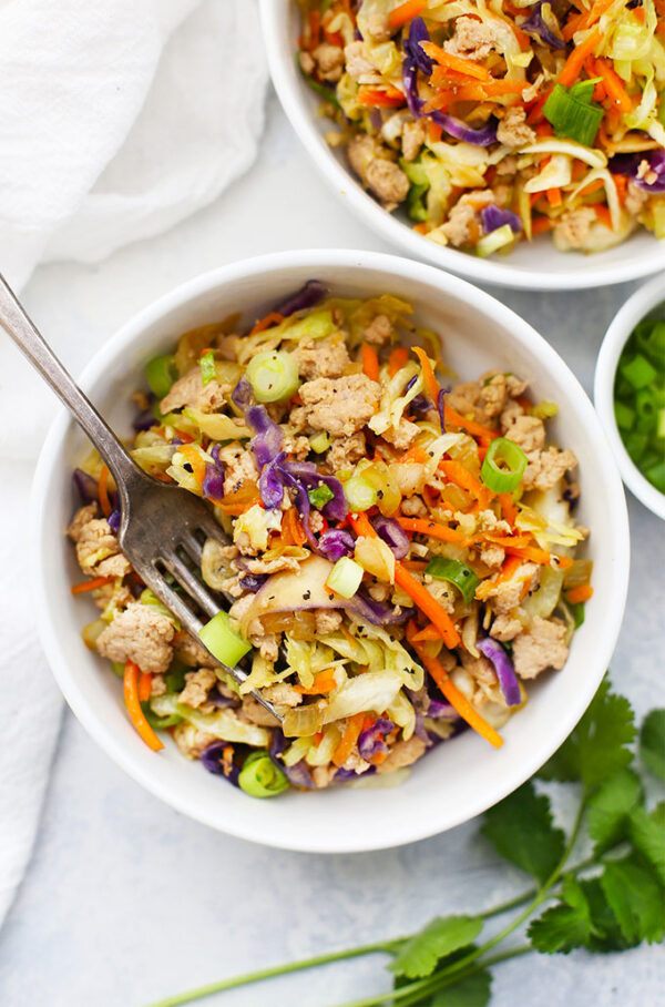 A bowl of food with meat and vegetables.