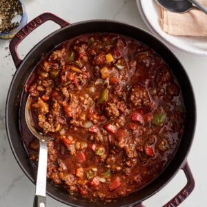 A bowl of chili with meat and vegetables.