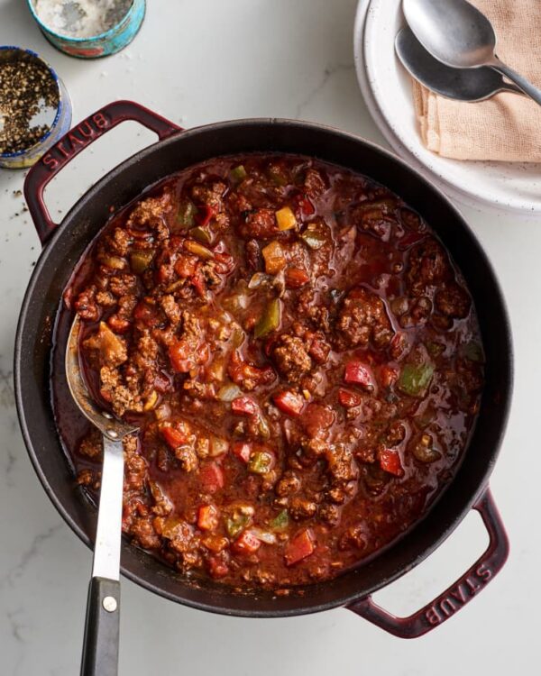 A bowl of chili with meat and vegetables.