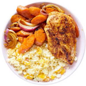 A bowl of rice, chicken and vegetables.